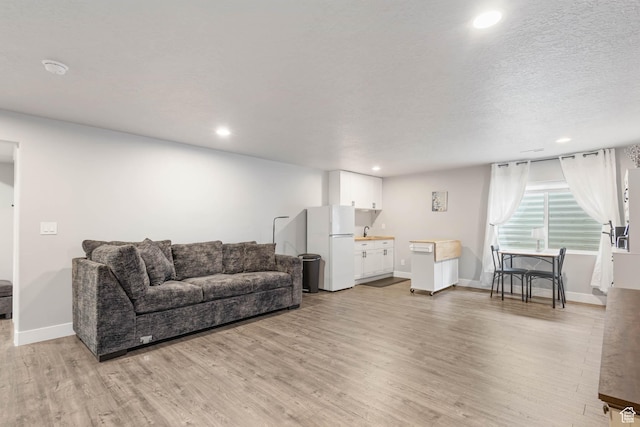 541 W 1960 N, Tooele, UT 84074 - living area featuring light wood finished floors, recessed lighting, and baseboards
