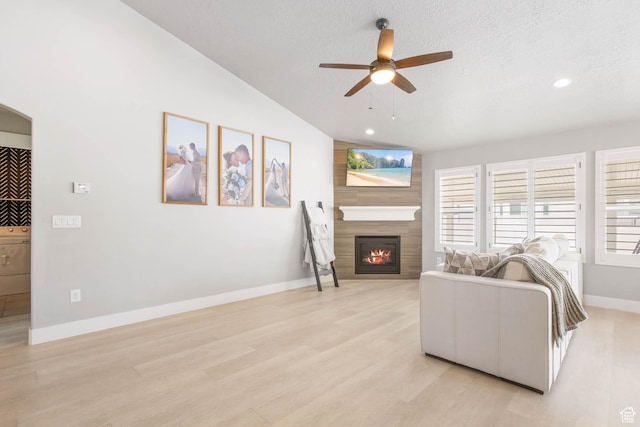 541 W 1960 N, Tooele, UT 84074 - living area featuring ceiling fan, a large fireplace, lofted ceiling, light wood-style flooring, and baseboards
