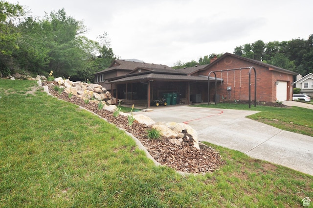 view of home's exterior featuring a yard, brick siding, a garage, concrete driveway, and a chimney