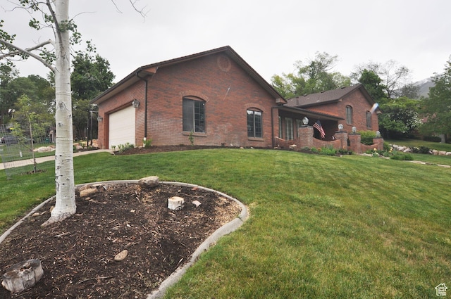view of home's exterior featuring brick siding, an attached garage, and a yard