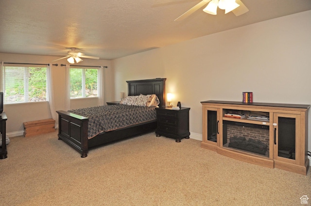 carpeted bedroom featuring baseboards and ceiling fan