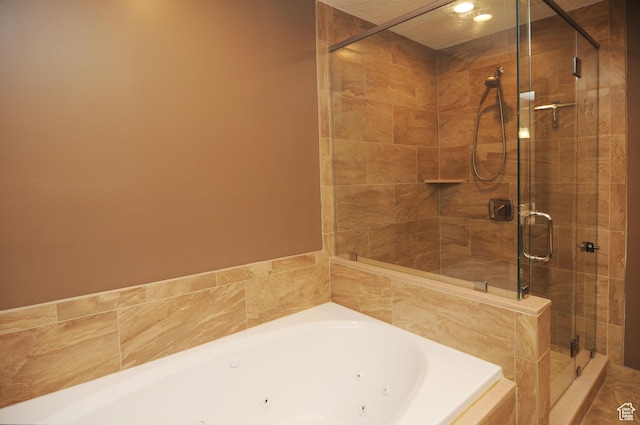full bath featuring a whirlpool tub and a shower stall