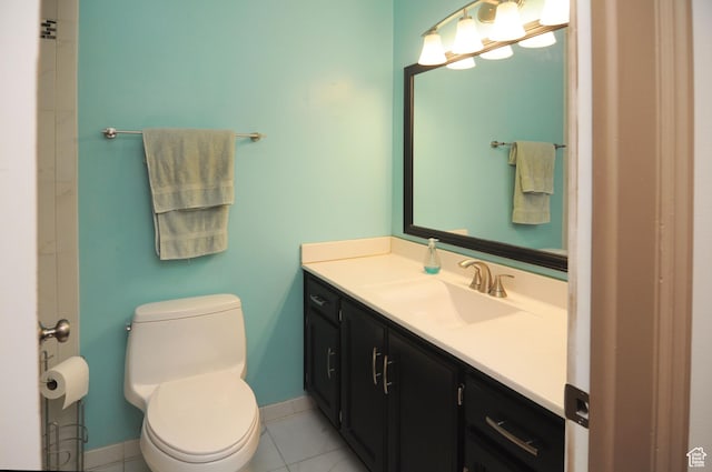 bathroom with toilet, baseboards, vanity, and tile patterned floors