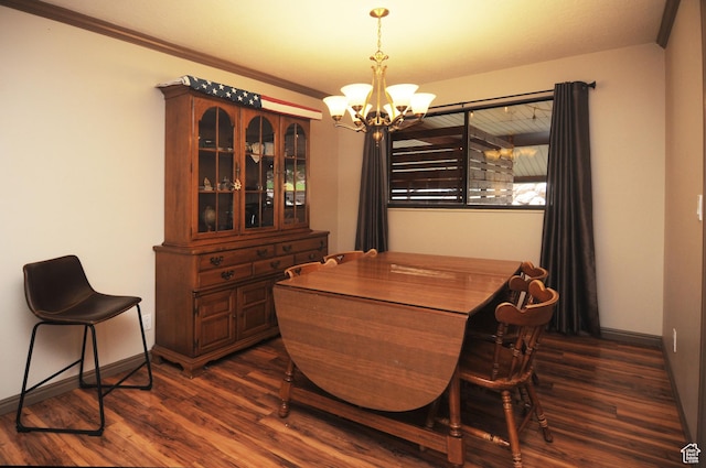 dining space with a chandelier, dark wood-type flooring, baseboards, and crown molding
