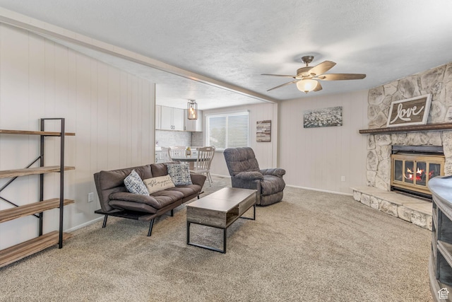 396 S 100 E, Tooele, UT 84074 - living room with a ceiling fan, carpet, a stone fireplace, baseboards, and wood walls