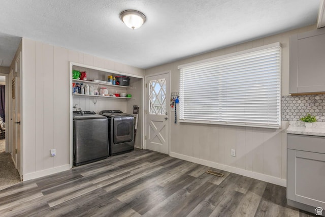 396 S 100 E, Tooele, UT 84074 - laundry area featuring washing machine and clothes dryer, wood finished floors, a textured ceiling, and baseboards