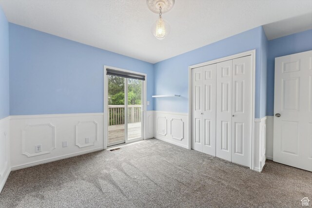 4948 S 1150 E, Ogden, UT 84403 - unfurnished bedroom featuring carpet, access to outside, a wainscoted wall, and a closet