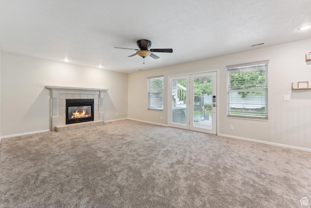 4948 S 1150 E, Ogden, UT 84403 - unfurnished living room featuring ceiling fan, a tiled fireplace, healthy amount of natural light, carpet, and recessed lighting