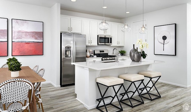 1077 W 400th St S Unit 43, Brigham City, UT 84302 - kitchen with appliances with stainless steel finishes, light wood-style flooring, baseboards, a breakfast bar, and recessed lighting