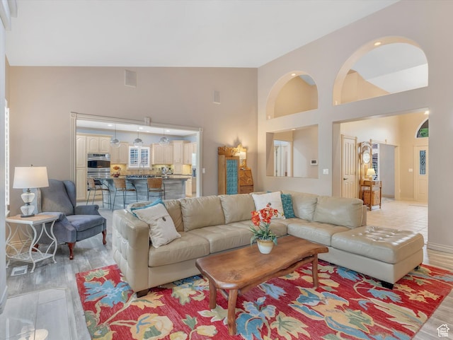 1921 E Mohawk Ln S, Ogden, UT 84403 - living area with high vaulted ceiling and light wood-style floors