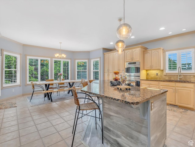 1921 E Mohawk Ln S, Ogden, UT 84403 - kitchen featuring a sink, double oven, light tile patterned floors, backsplash, and a kitchen breakfast bar