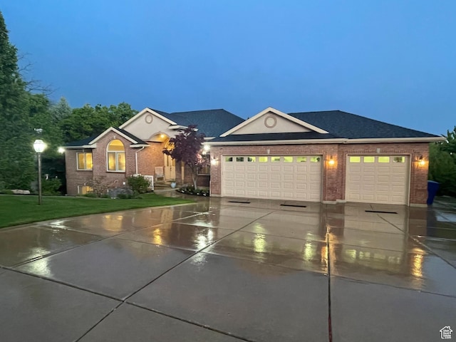 1921 E Mohawk Ln S, Ogden, UT 84403 - ranch-style house featuring concrete driveway, brick siding, a garage, and a lawn