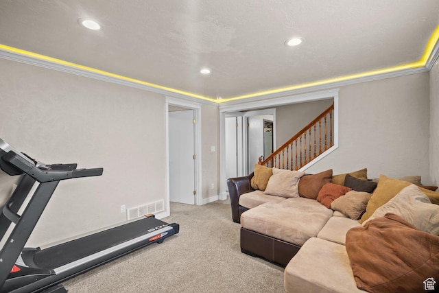 exercise room featuring ornamental molding, light carpet, and recessed lighting