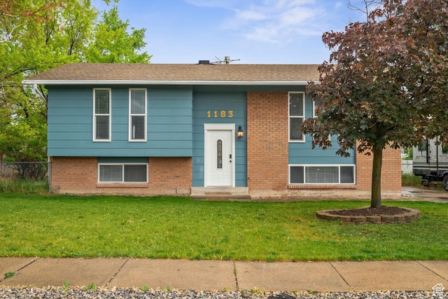 bi-level home featuring brick siding