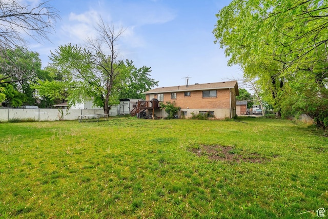 view of yard featuring a deck and stairs