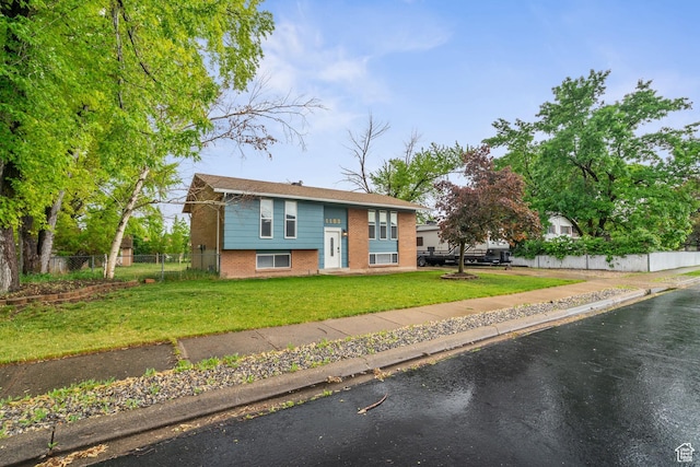 raised ranch featuring brick siding