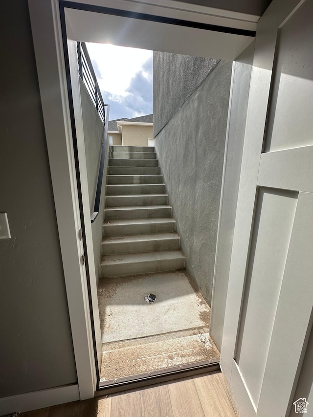 stairway featuring wood finished floors