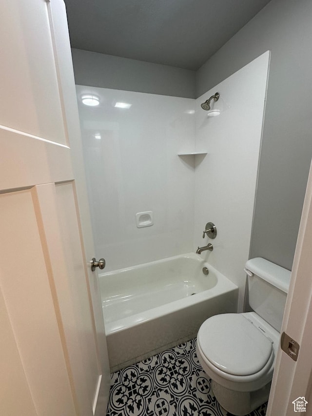 full bath featuring toilet, tile patterned flooring, and shower / bath combination