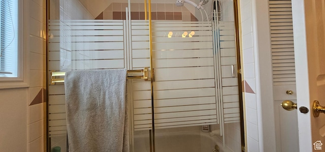 full bathroom featuring bath / shower combo with glass door