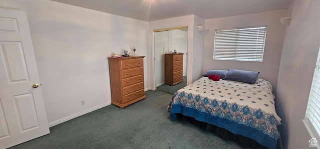 bedroom with carpet flooring, baseboards, and a closet