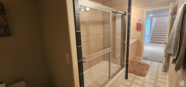 full bathroom with bath / shower combo with glass door, tile patterned floors, and vanity