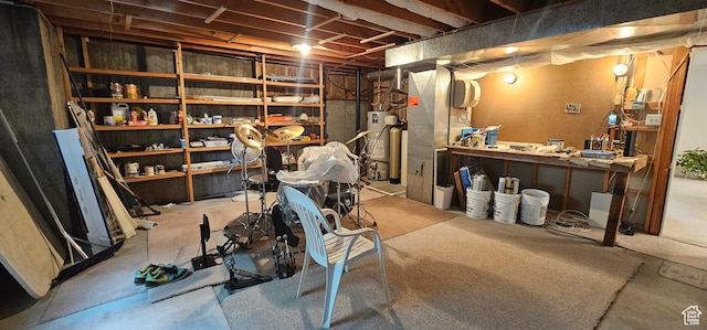 unfinished basement featuring gas water heater and a workshop area