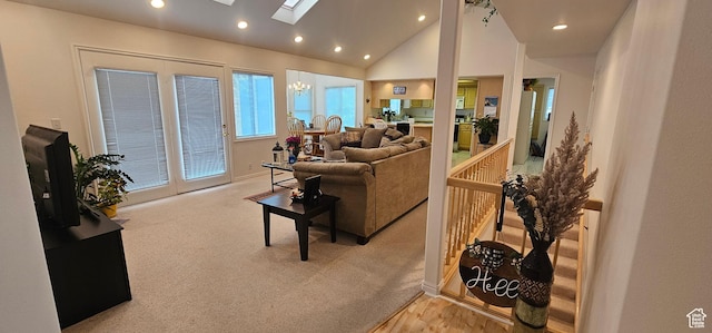 living area with recessed lighting, a skylight, lofted ceiling, baseboards, and carpet floors