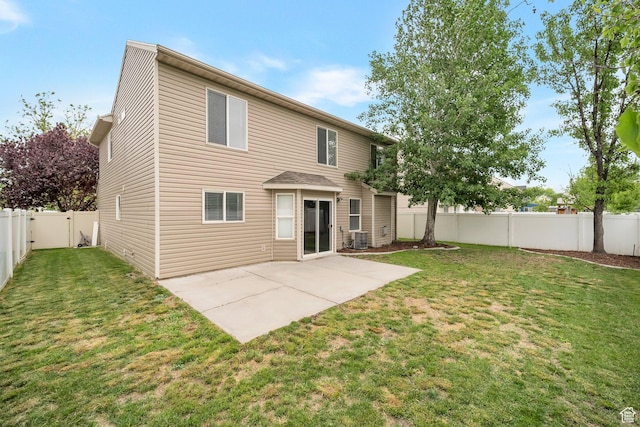 rear view of house with central air condition unit and a patio area