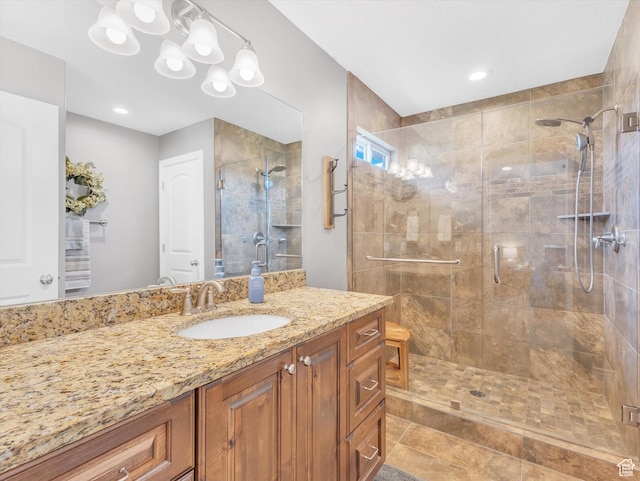 full bathroom with a shower stall and vanity
