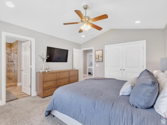 bedroom featuring light colored carpet, lofted ceiling, a closet, a ceiling fan, and connected bathroom