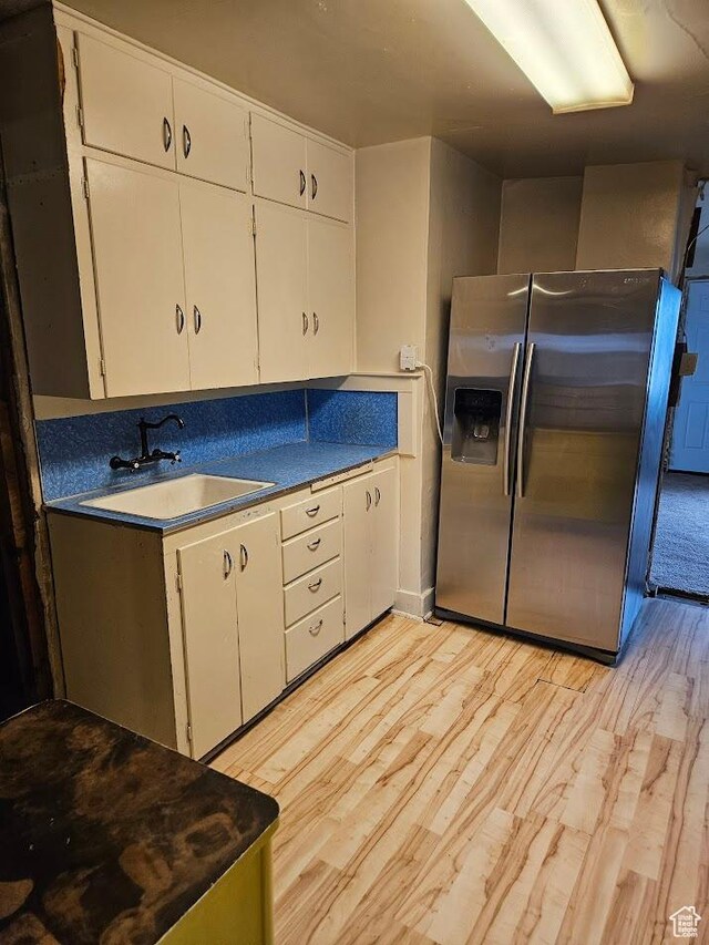 139 E 4th S, Preston, ID 83263 - kitchen featuring stainless steel fridge, a sink, white cabinetry, and light wood finished floors