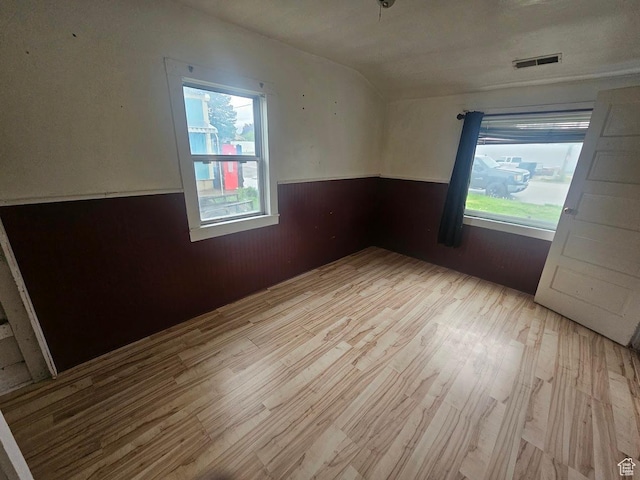 139 E 4th S, Preston, ID 83263 - unfurnished room with wood finished floors, a wainscoted wall, wooden walls, and vaulted ceiling