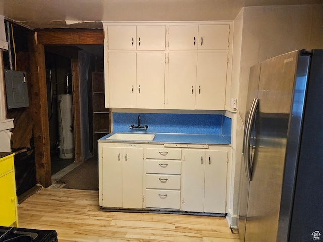 139 E 4th S, Preston, ID 83263 - kitchen with freestanding refrigerator, a sink, water heater, white cabinets, and light wood-style flooring