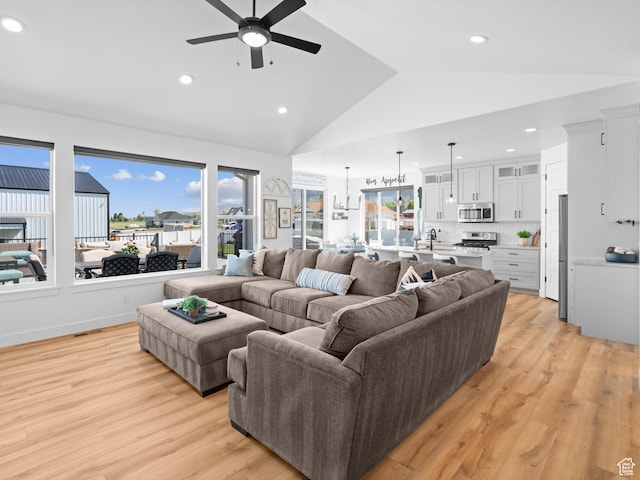 living area featuring ceiling fan, lofted ceiling, light wood finished floors, and recessed lighting