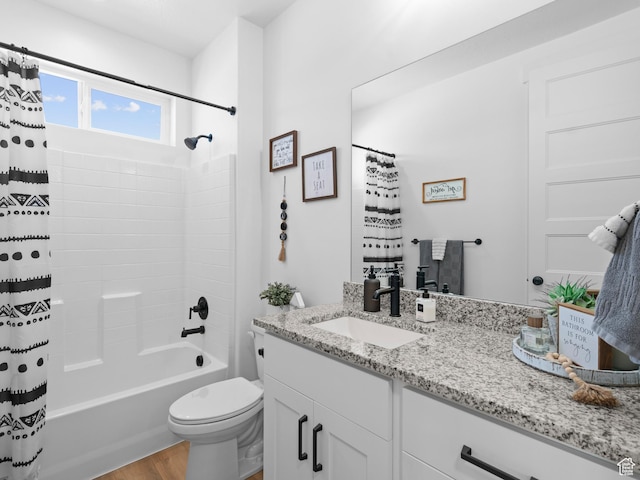 bathroom featuring vanity, toilet, wood finished floors, and shower / tub combo
