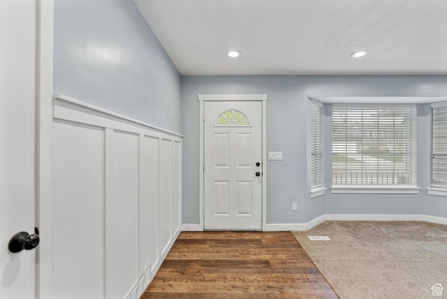 entryway featuring recessed lighting, carpet floors, and baseboards