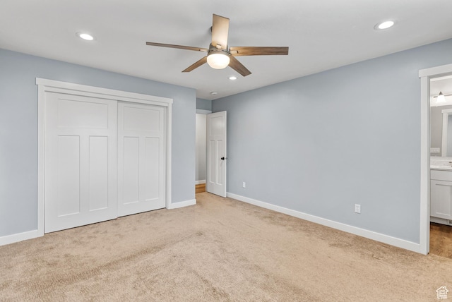 unfurnished bedroom featuring carpet floors, baseboards, recessed lighting, connected bathroom, and a closet