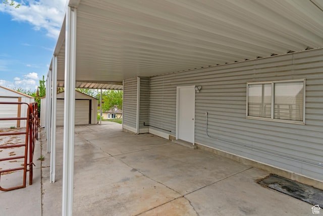 view of patio / terrace with an outdoor structure and a shed