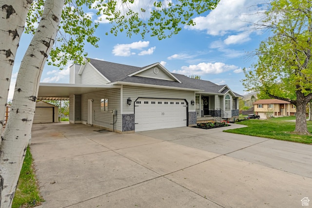 view of front of property featuring concrete driveway, a garage, roof with shingles, and a front lawn