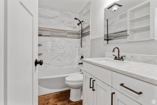 bathroom featuring toilet, vanity, shower / bathtub combination, and wood finished floors