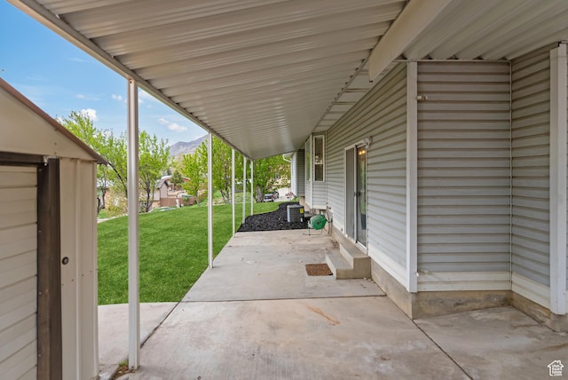 view of patio / terrace featuring a mountain view and central air condition unit
