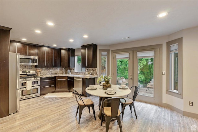 59 W 600 N, Farmington, UT 84025 - kitchen featuring stainless steel appliances, dark brown cabinets, french doors, tasteful backsplash, and plenty of natural light