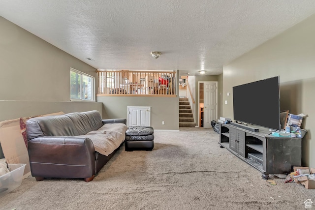living area with stairs, a textured ceiling, and carpet