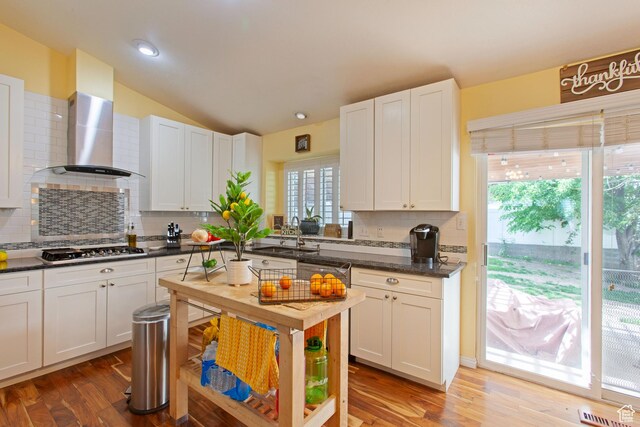 841 W 1235 S, Payson, UT 84651 - kitchen with stainless steel gas cooktop, a sink, decorative backsplash, dark countertops, and wall chimney range hood
