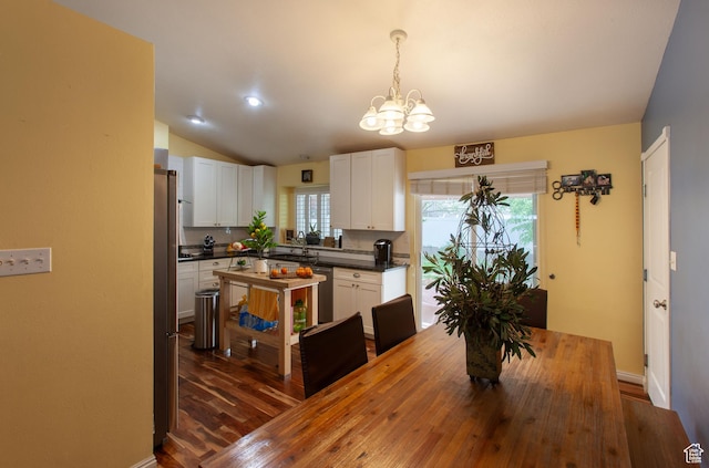 841 W 1235 S, Payson, UT 84651 - dining space with a chandelier, vaulted ceiling, dark wood-type flooring, and baseboards