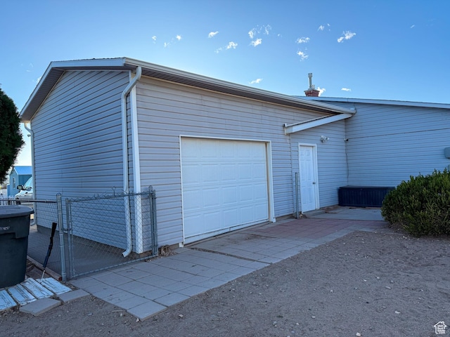 garage featuring a gate and fence