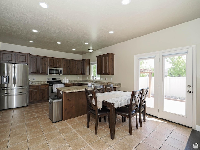 3263 W Blue Moon Ln, South Jordan, UT 84095 - kitchen with stainless steel appliances, recessed lighting, dark brown cabinets, light tile patterned flooring, and a sink