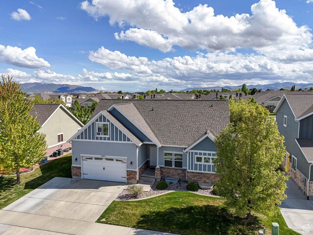 3263 W Blue Moon Ln, South Jordan, UT 84095 - craftsman house featuring a residential view, driveway, stone siding, and a mountain view