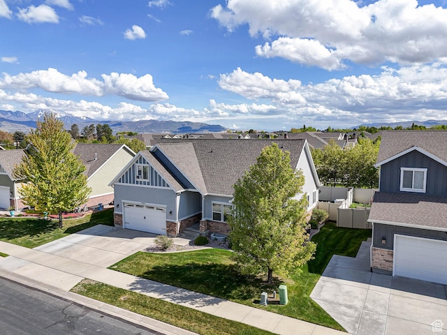 3263 W Blue Moon Ln, South Jordan, UT 84095 - view of front of home with stone siding, driveway, a garage, a shingled roof, and a mountain view