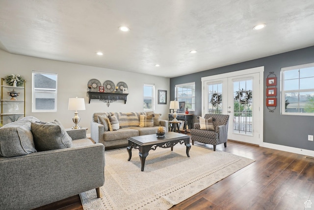 living area with healthy amount of natural light, recessed lighting, dark wood-style floors, baseboards, and french doors